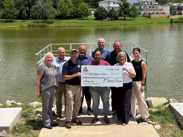 Staff from JC Parks and MDC hold check from ORIG Grant at McKay Park