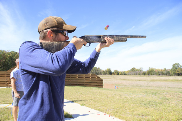 a man shoots with a shotgun
