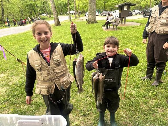 two kids holding caught trout