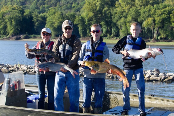 four anglers holding catfish